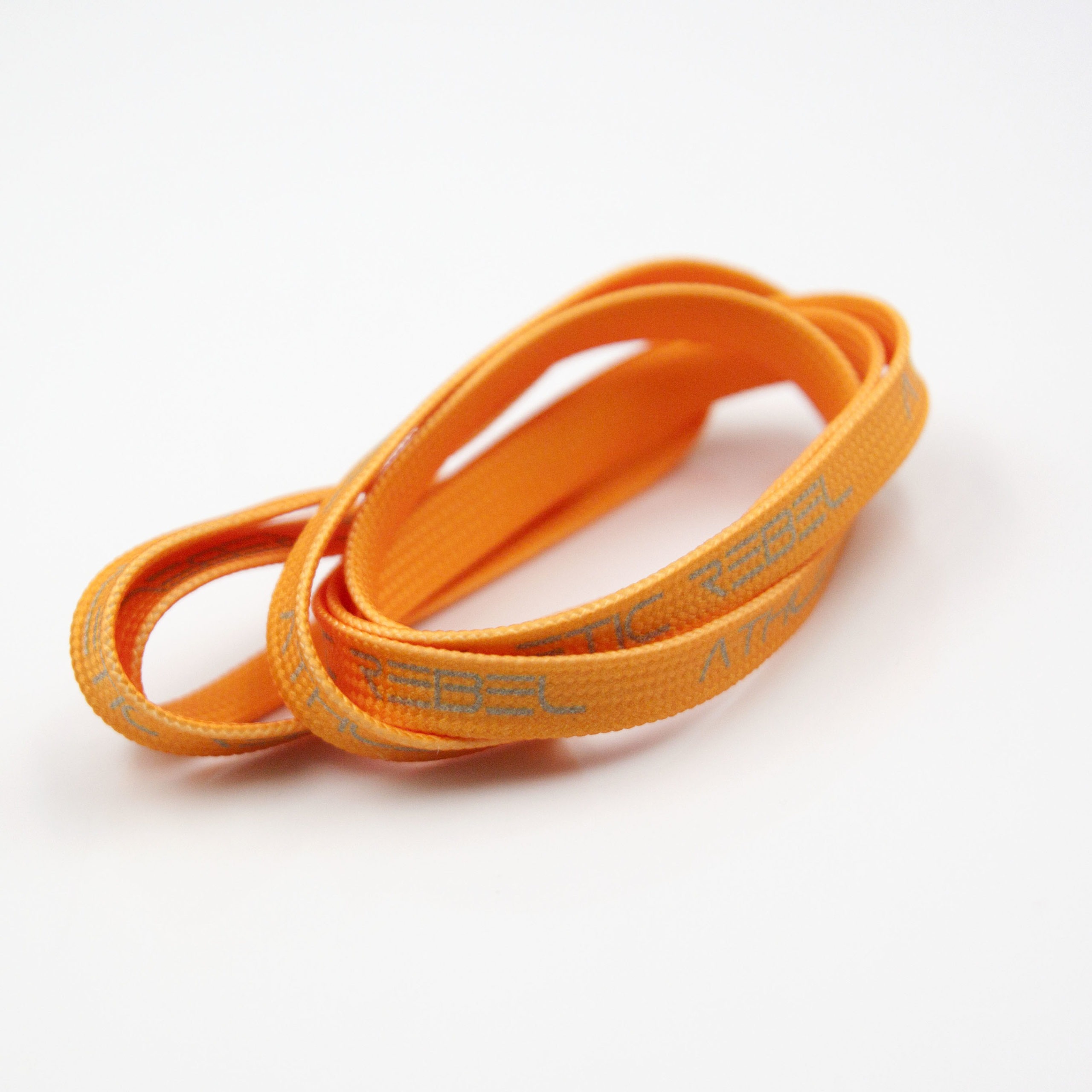 Tasiemka pleciona tunelowa drukowana, w kolorze pomarańczowym z szarym wzorem, do odzieży.